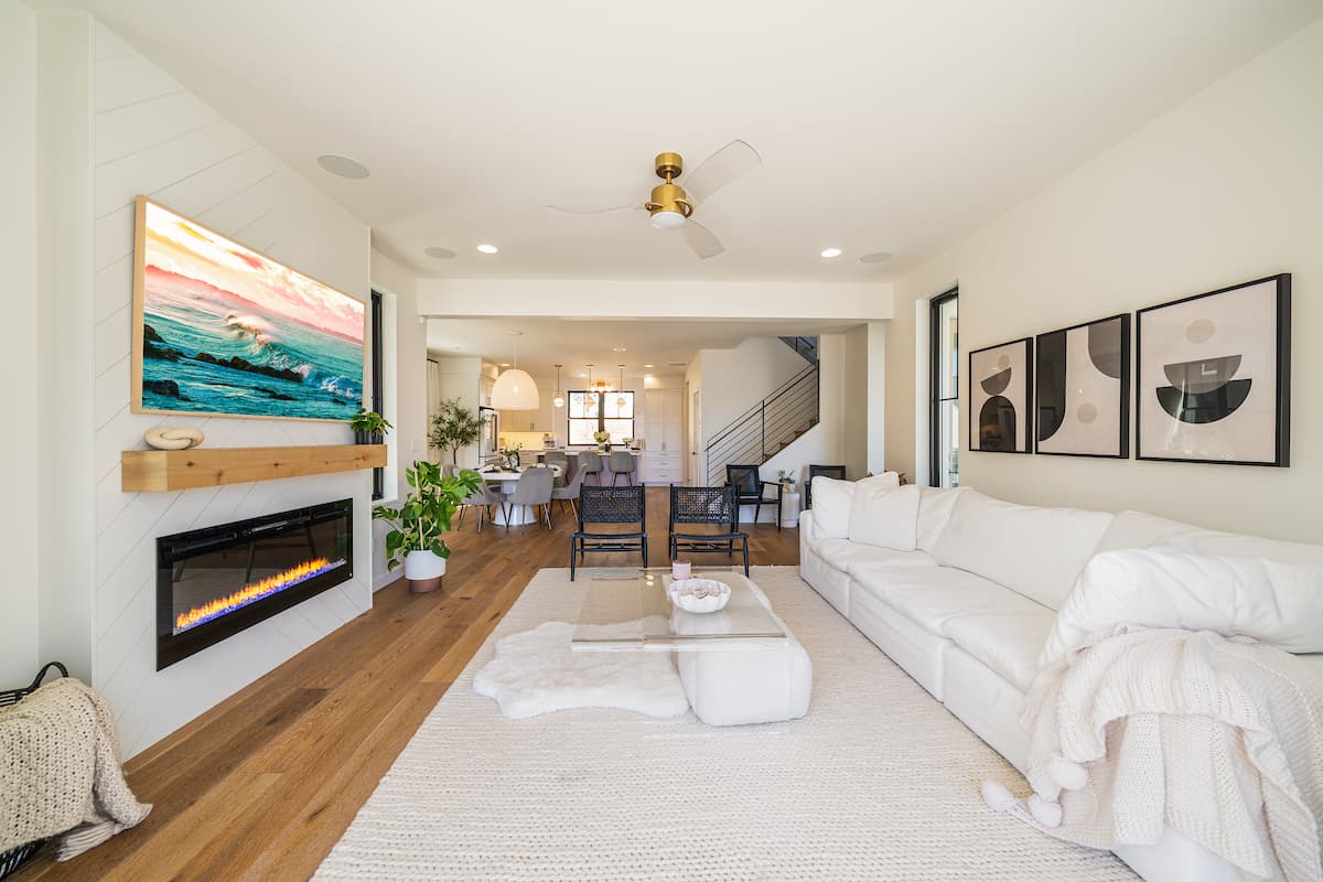 Bright great room at Coco Chelan with fireplace and open kitchen beyond